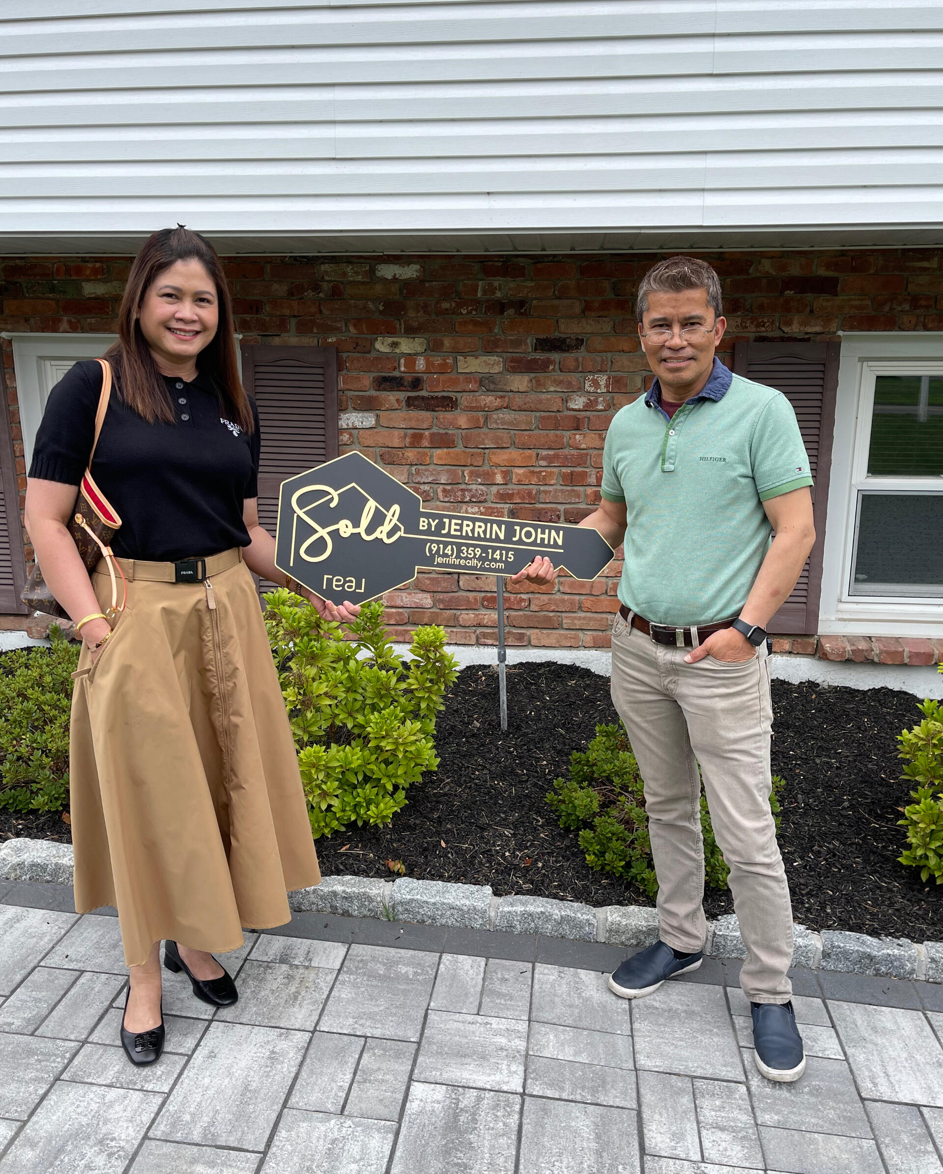 Jerrin John Real Estate Client holding house Key after closing